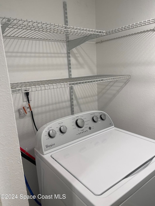 clothes washing area with washer / dryer