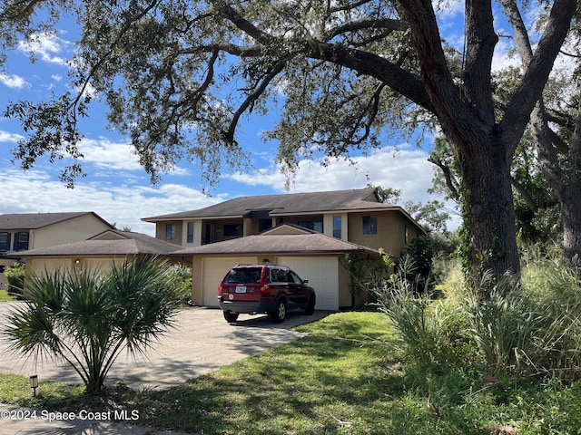 view of front of home featuring a garage and a front lawn