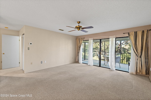 empty room with light carpet, a textured ceiling, and ceiling fan