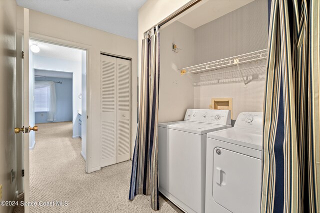 laundry room featuring light carpet and independent washer and dryer