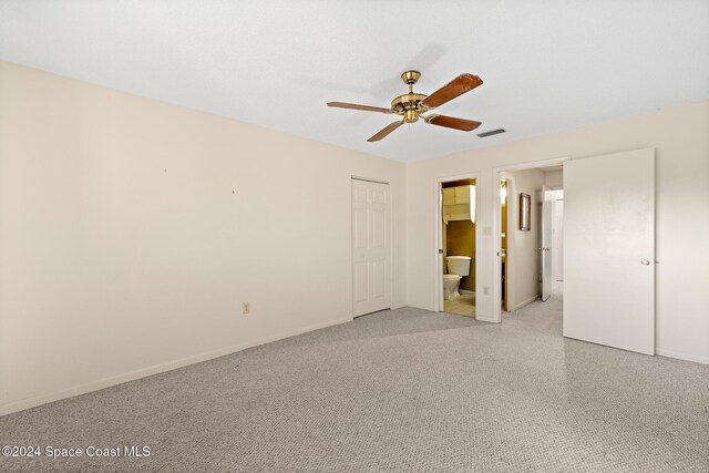 unfurnished bedroom featuring ensuite bathroom and ceiling fan