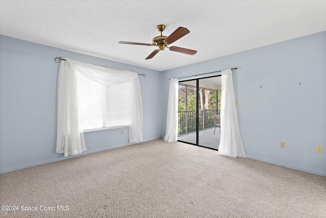 unfurnished room with carpet, a textured ceiling, and ceiling fan