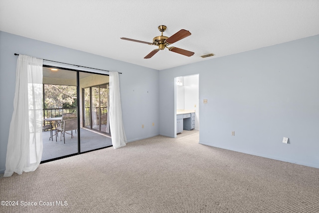 spare room featuring ceiling fan and light colored carpet