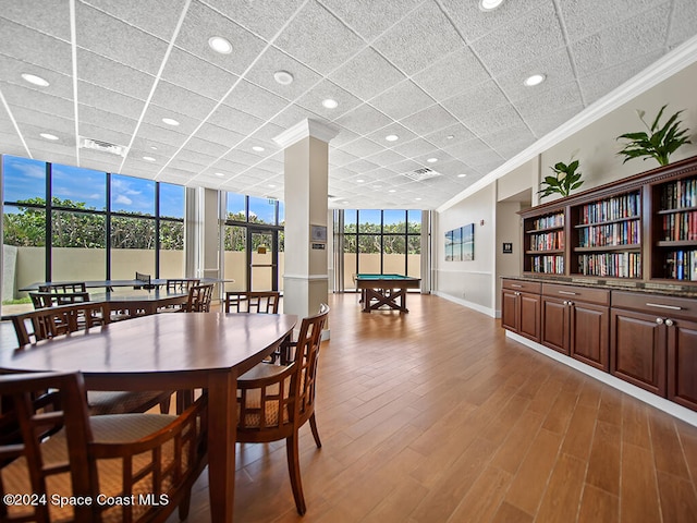 dining room with ornamental molding, a wall of windows, pool table, and wood-type flooring