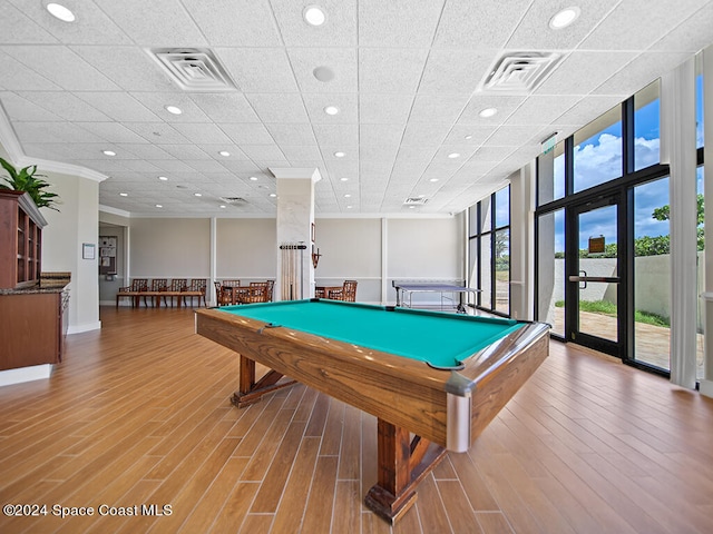 recreation room with pool table, hardwood / wood-style floors, floor to ceiling windows, and ornamental molding