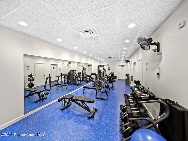 gym with a paneled ceiling