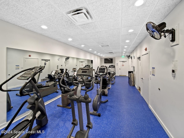 exercise room with a paneled ceiling