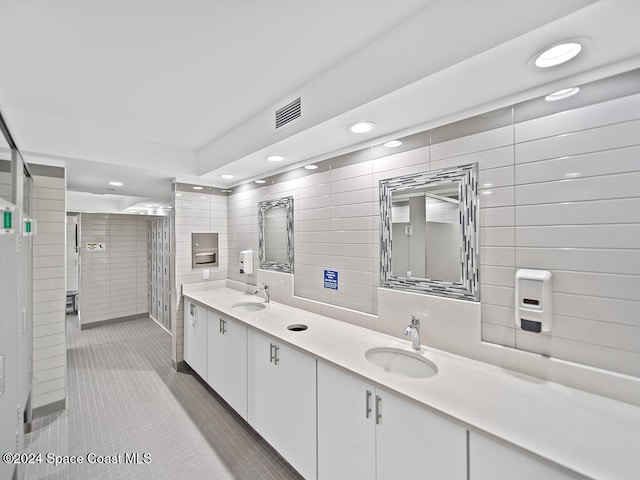 bathroom featuring vanity, tile walls, and tile patterned flooring