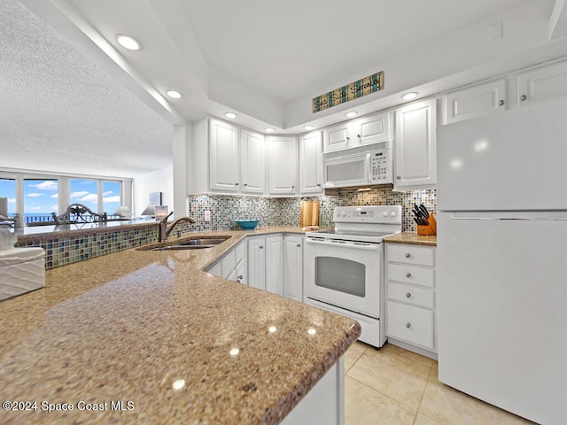 kitchen featuring sink, white cabinetry, white appliances, and light tile patterned floors