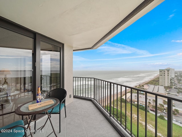 balcony with a water view and a beach view