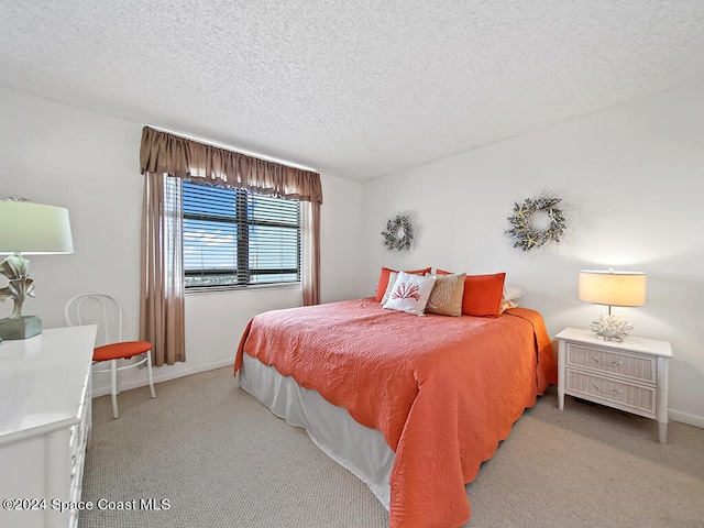 carpeted bedroom featuring a textured ceiling