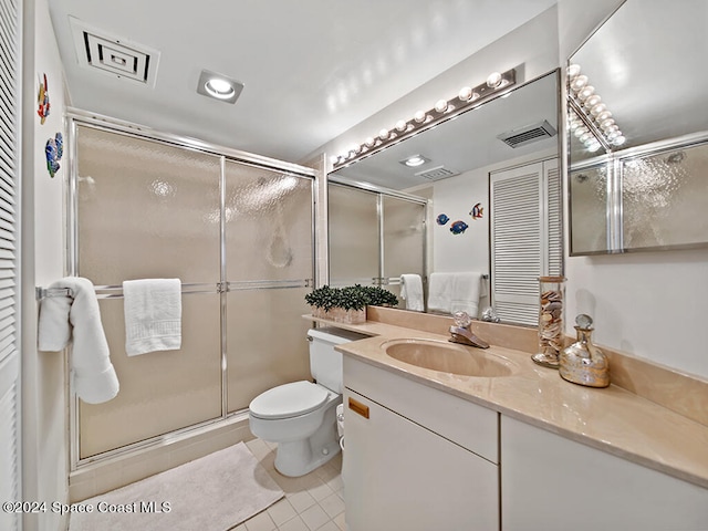 bathroom with vanity, walk in shower, toilet, and tile patterned flooring