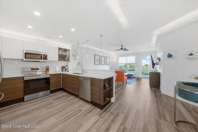 202 Ivory Coral Ln Unit 405, Merritt Island, FL 32953 - kitchen with appliances with stainless steel finishes, open floor plan, a sink, a peninsula, and recessed lighting