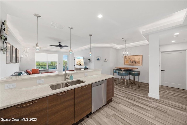 202 Ivory Coral Ln Unit 405, Merritt Island, FL 32953 - kitchen featuring stainless steel dishwasher, a sink, open floor plan, light wood-style flooring, and pendant lighting