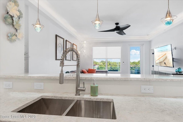 202 Ivory Coral Ln Unit 405, Merritt Island, FL 32953 - kitchen featuring a sink, ceiling fan, light stone counters, and pendant lighting
