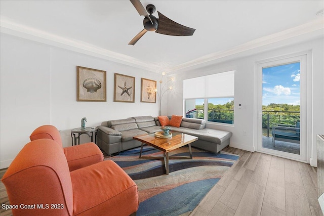 living room featuring crown molding, hardwood / wood-style flooring, and ceiling fan