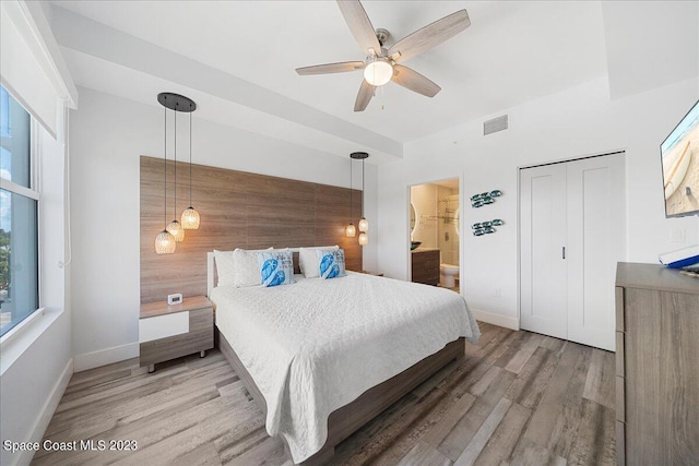 202 Ivory Coral Ln Unit 405, Merritt Island, FL 32953 - bedroom featuring light wood-style floors, baseboards, connected bathroom, and ceiling fan