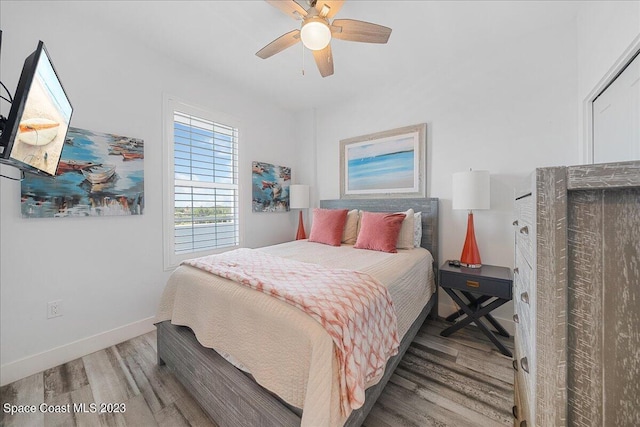 bedroom featuring hardwood / wood-style flooring and ceiling fan