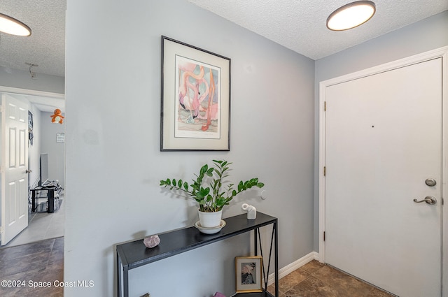 entryway featuring a textured ceiling