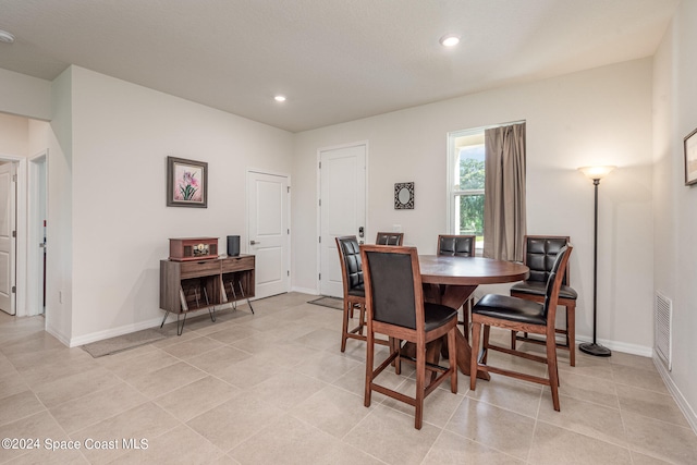 dining area featuring light tile patterned flooring