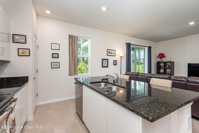 kitchen with white cabinetry, sink, a center island with sink, and plenty of natural light