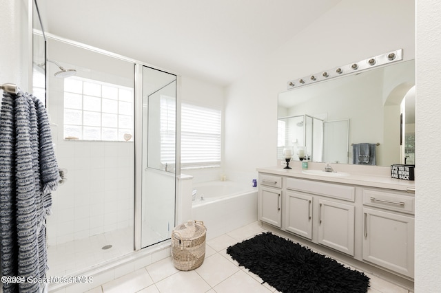 bathroom featuring vanity, shower with separate bathtub, and tile patterned flooring