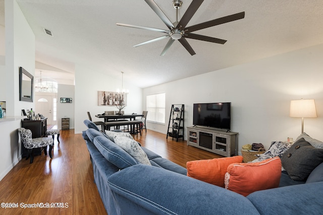 living room with lofted ceiling, a textured ceiling, ceiling fan with notable chandelier, and dark hardwood / wood-style flooring