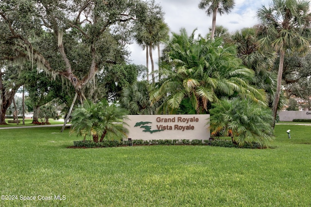 community sign featuring a lawn