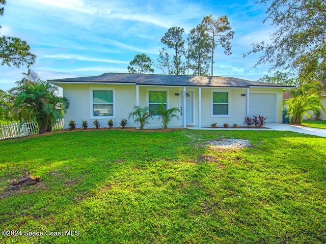 ranch-style home with a front lawn and a garage