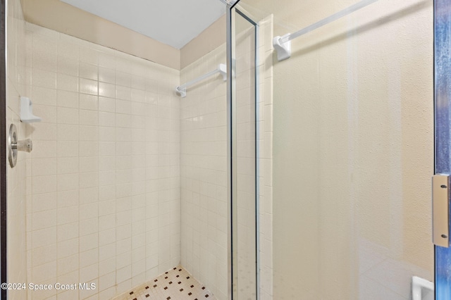 bathroom with a tile shower