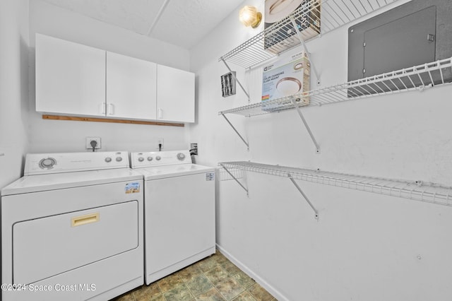 laundry area with separate washer and dryer and cabinets