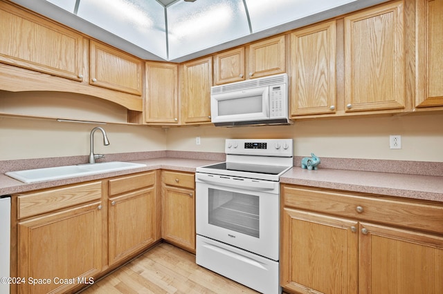 kitchen with white appliances, light hardwood / wood-style flooring, light brown cabinets, and sink