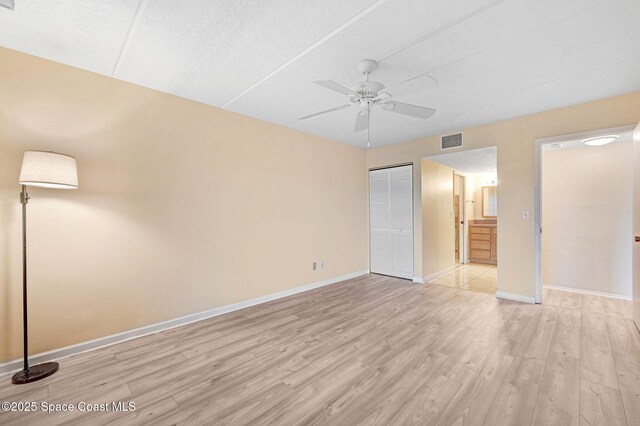 2775 N Wickham Rd Unit 203, Melbourne, FL 32935 - unfurnished bedroom featuring light wood finished floors, a closet, and ceiling fan
