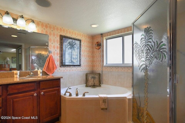 bathroom with vanity, plus walk in shower, and a textured ceiling