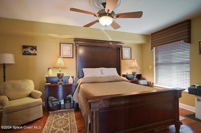 bedroom with ceiling fan and dark hardwood / wood-style floors