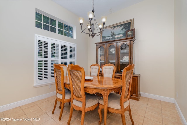 tiled dining area featuring a chandelier