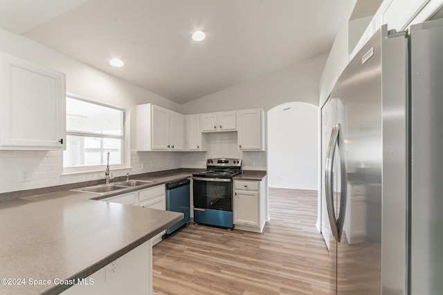 kitchen featuring white cabinetry, light hardwood / wood-style flooring, appliances with stainless steel finishes, and lofted ceiling