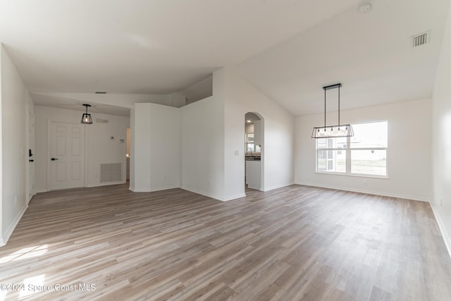 unfurnished living room featuring lofted ceiling and light wood-type flooring