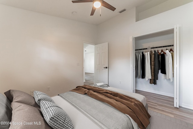 bedroom with a closet, hardwood / wood-style floors, and ceiling fan