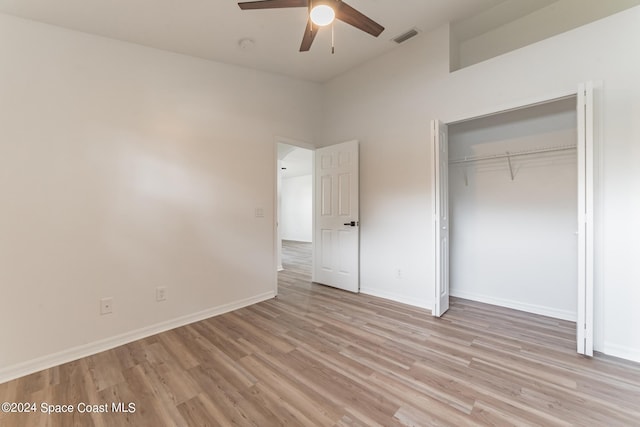 unfurnished bedroom featuring light hardwood / wood-style flooring, a closet, and ceiling fan