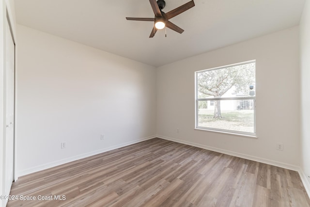 unfurnished room with ceiling fan and light wood-type flooring