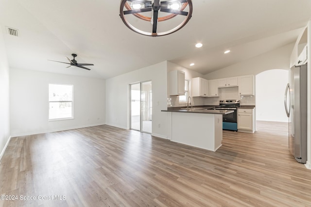 kitchen featuring ceiling fan, white cabinetry, vaulted ceiling, light hardwood / wood-style flooring, and stainless steel appliances