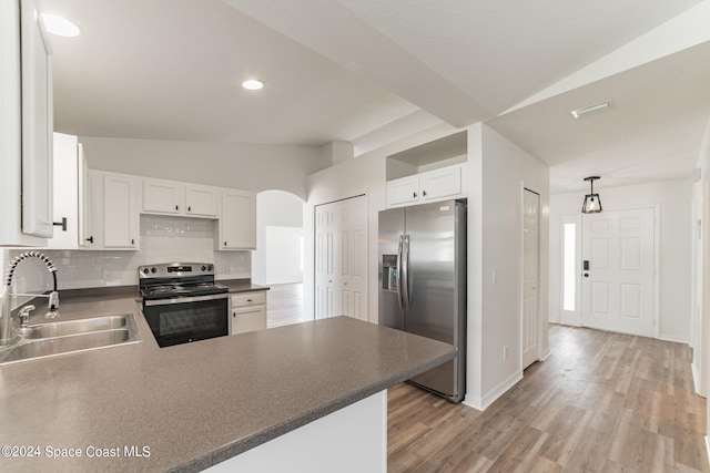 kitchen with white cabinetry, stainless steel appliances, sink, and hanging light fixtures