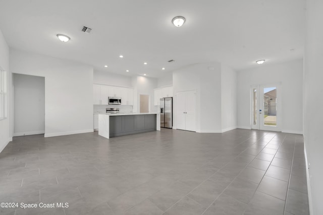 unfurnished living room featuring light tile patterned floors