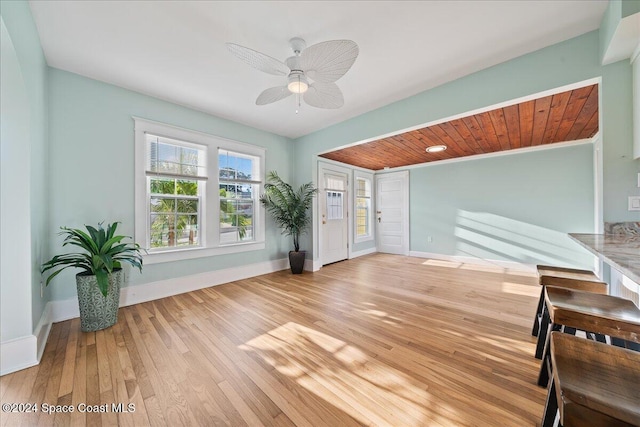 interior space featuring ceiling fan, wood ceiling, and light hardwood / wood-style flooring