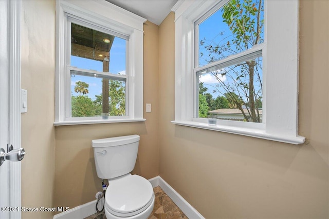 bathroom featuring toilet and a healthy amount of sunlight