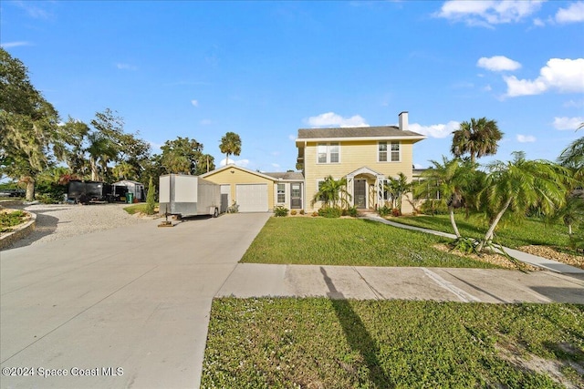 view of front of property with a front lawn and a garage