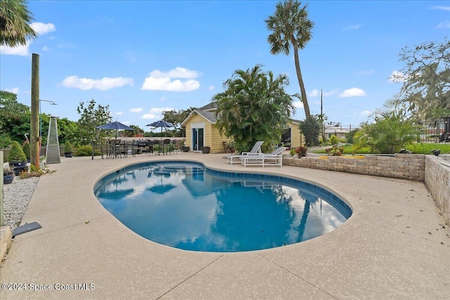 view of swimming pool featuring a patio area