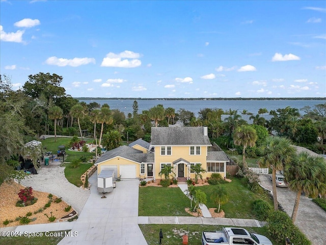 birds eye view of property with a water view