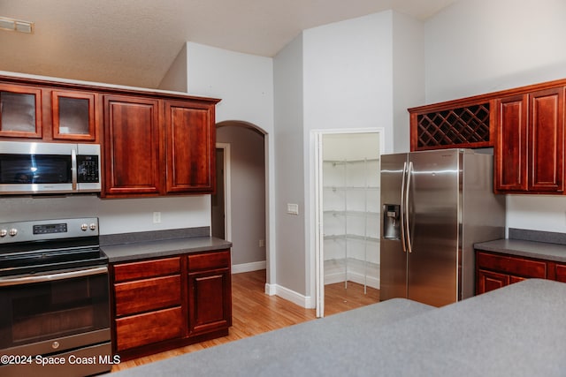 kitchen featuring appliances with stainless steel finishes and light hardwood / wood-style flooring